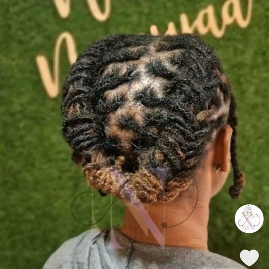 Person with braided hair against a green background